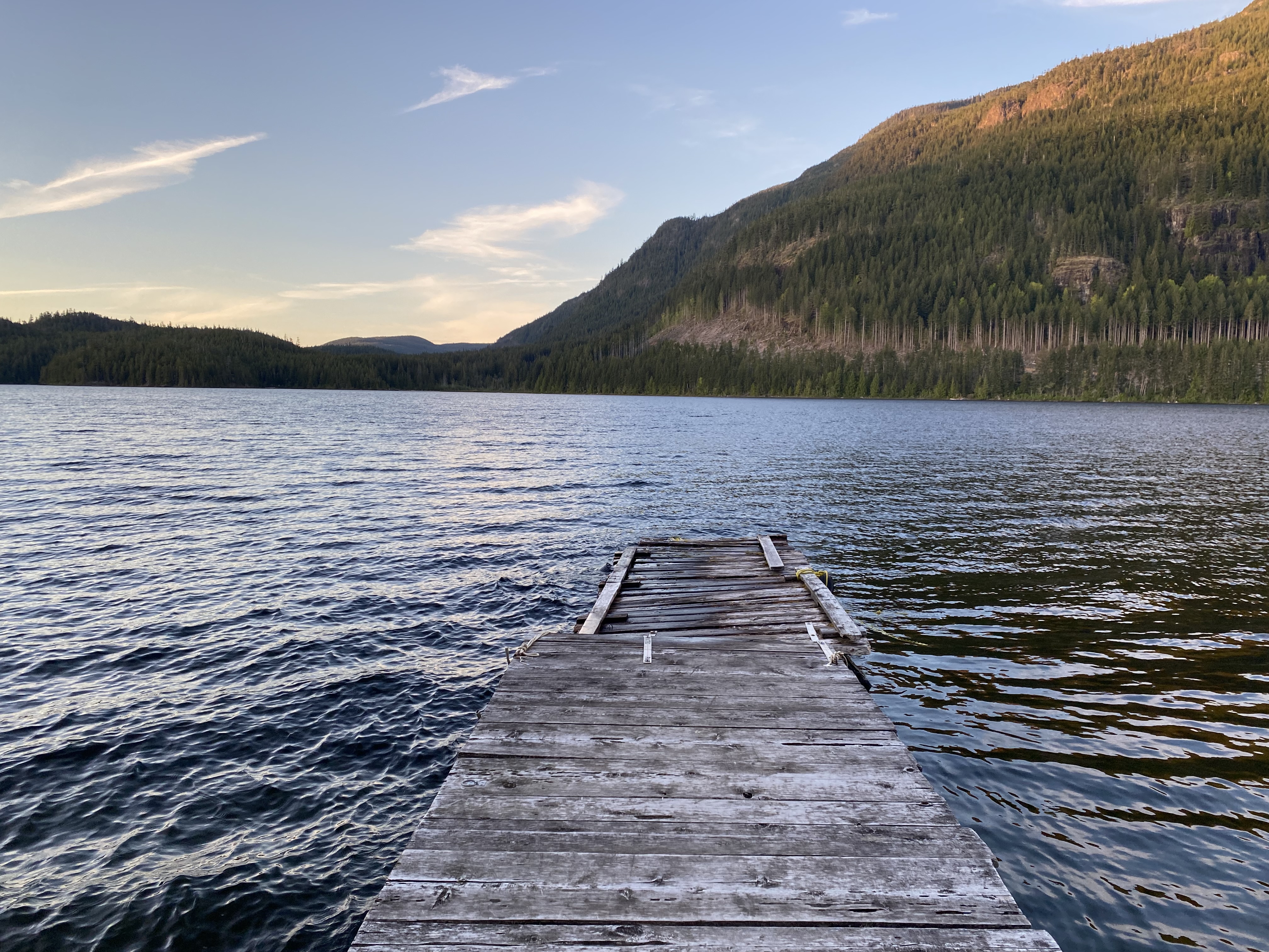 A wooden dock extending into Roberts Lake in British Columbia.